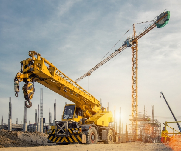 Mobile Crane on a road and tower crane in construction site